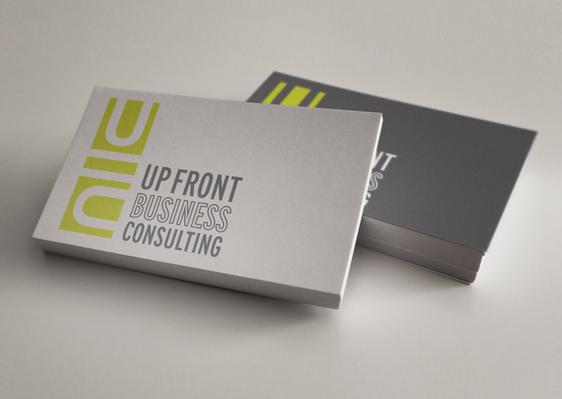 Business cards featuring a stacked green block logo for Up Front Business Consulting