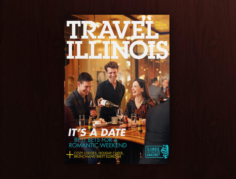 The cover of Travel Illinois Magazine featuring a server pouring wine for two happy people in an upscale restaurant