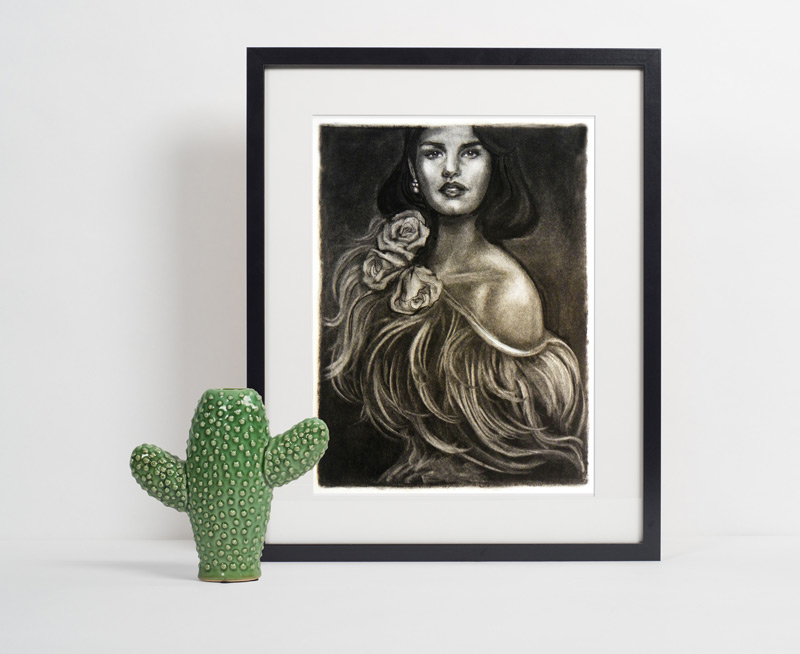 A charcoal illustration of a young woman wearing pearl earrings, a feathery gown and a corsage of roses, in a black frame accented by a ceramic cactus